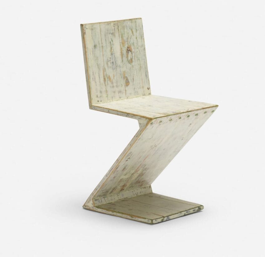 Rustic wooden Z-shaped chair with a distressed finish on a white background.