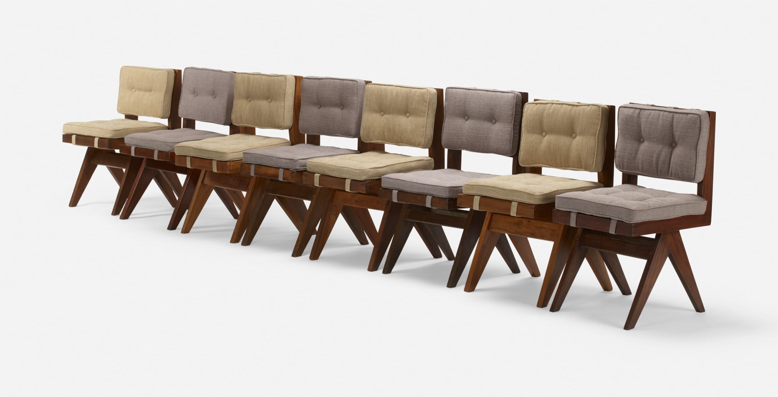 Eight vintage wooden chairs with padded seats and backs arranged in a row on a white background.