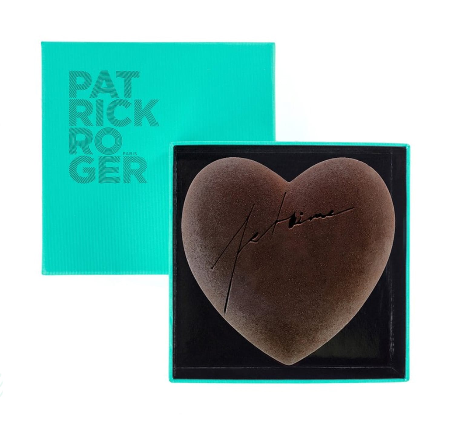 Heart-shaped chocolate in a turquoise box with black cursive writing on top, brand name visible on box lid.