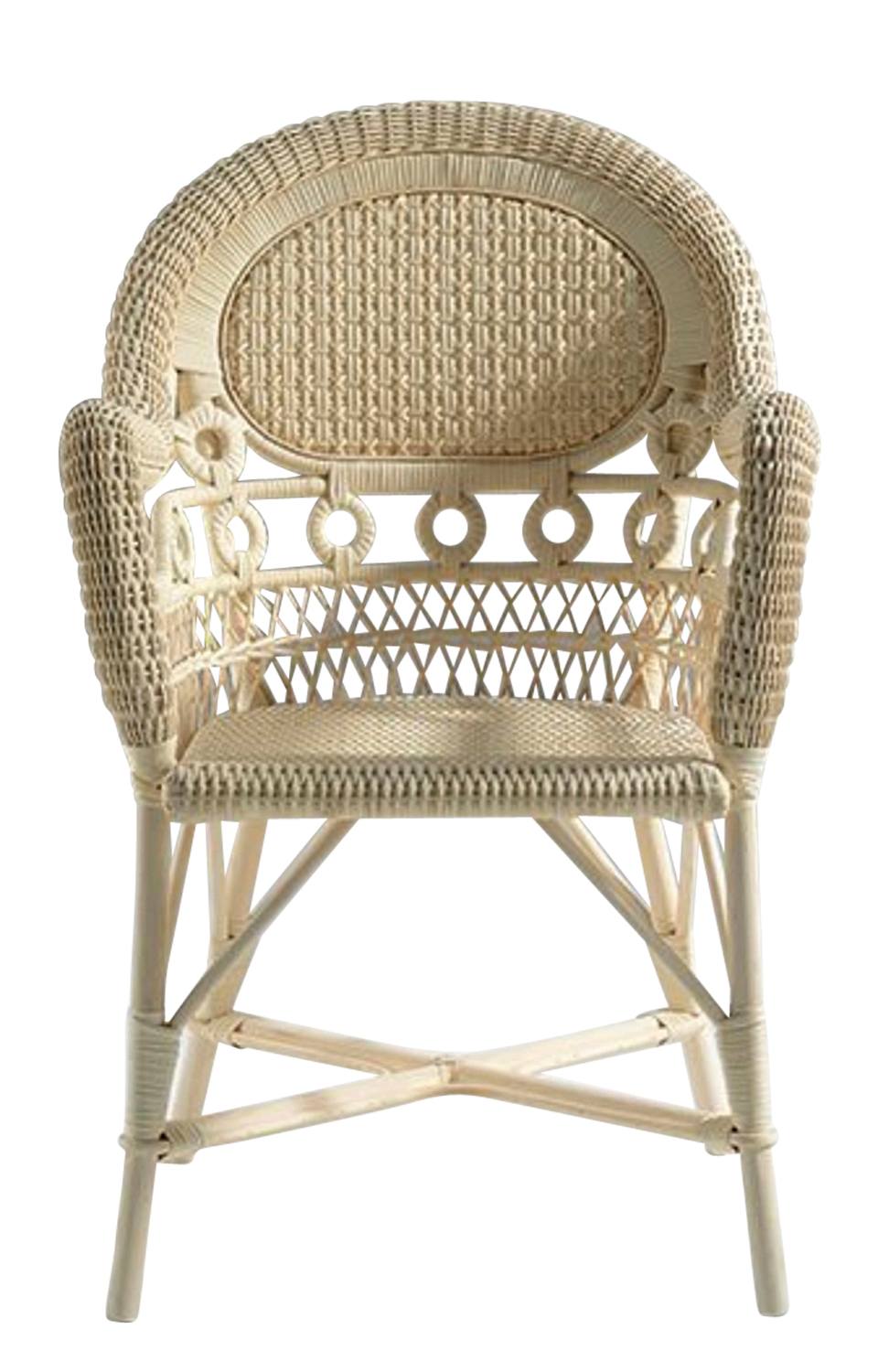 Front view of an intricately woven beige wicker chair with circular and crisscross patterns on the back and arms.