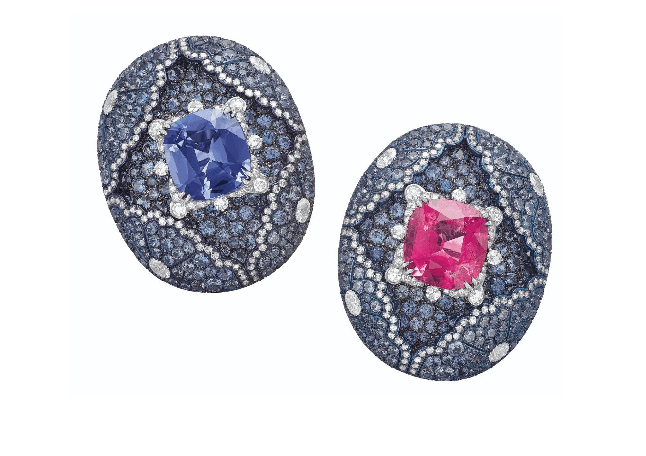 Decorative blue oval brooches with intricate patterns, one featuring a blue gemstone, the other a pink gemstone.