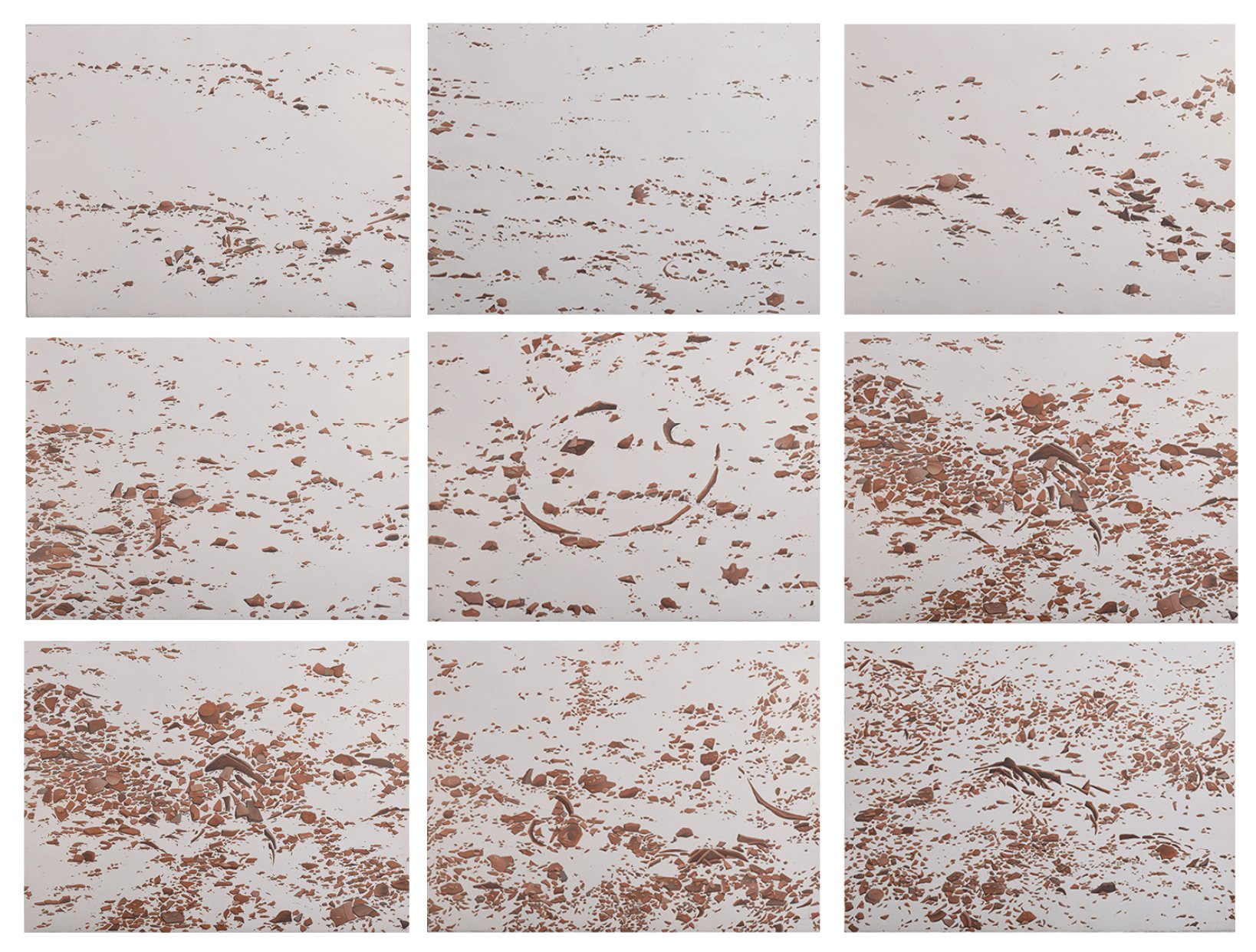 Nine abstract panels with scattered brown markings on a white background, creating a textured and dynamic visual pattern.