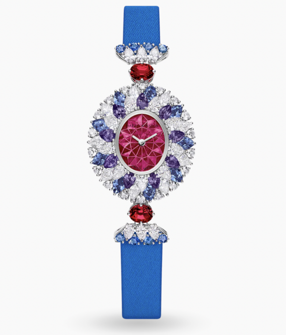 Luxurious watch with blue strap, featuring diamonds, red and purple gemstones, oval face, and intricate design.