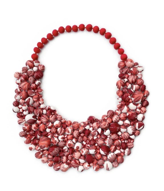 Red statement necklace with clusters of small beads and shells.