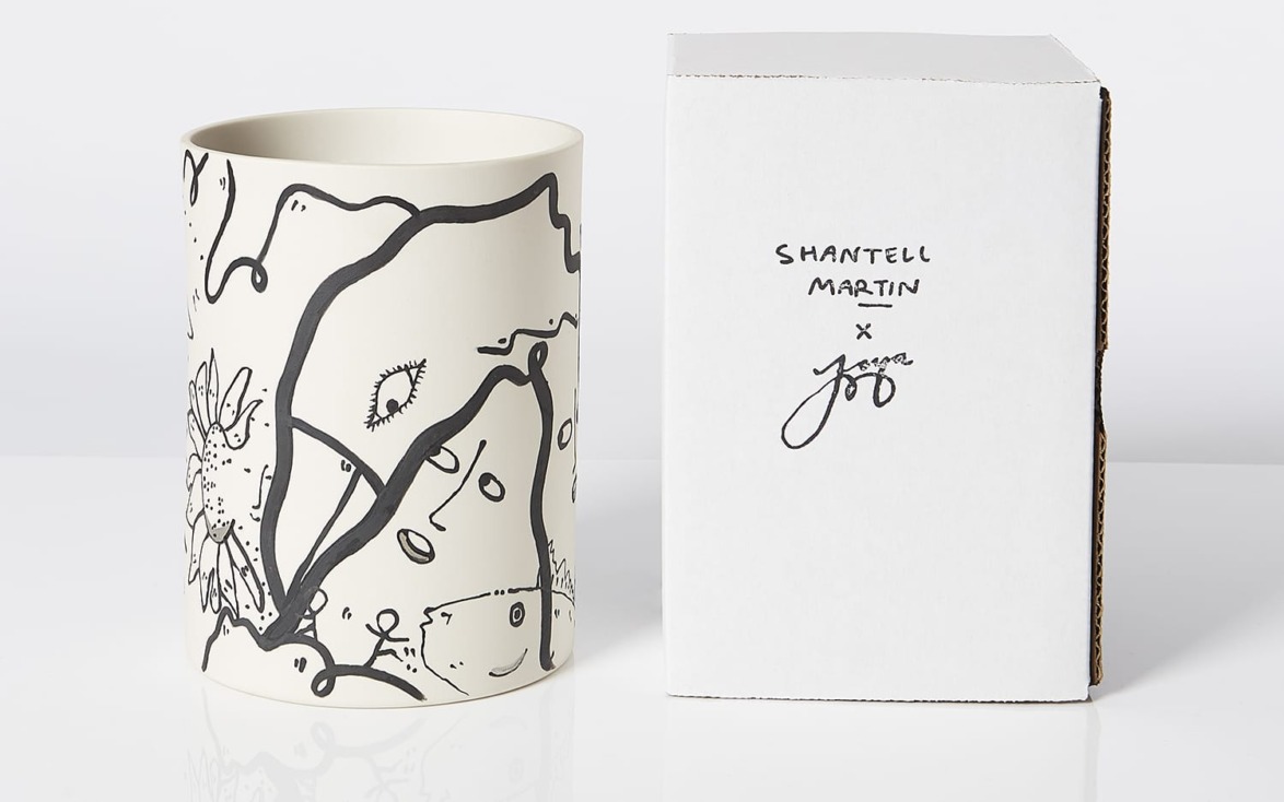 Decorative vase with abstract black and white designs beside a white box featuring handwritten signatures.