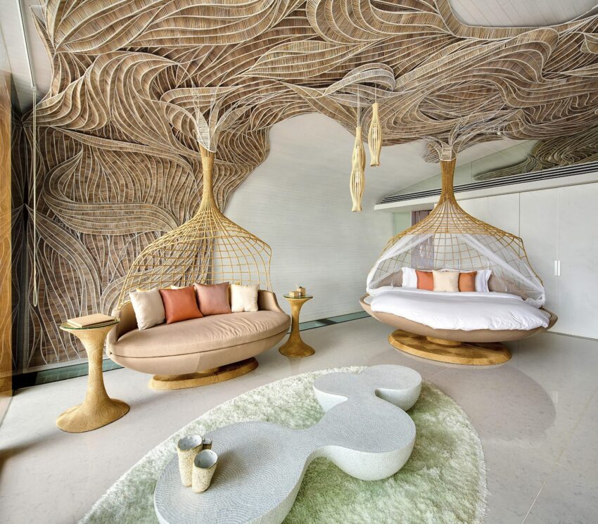 Modern room with unique hanging wicker chairs, abstract ceiling design, soft pillows, and elegant coffee tables on a plush carpet.