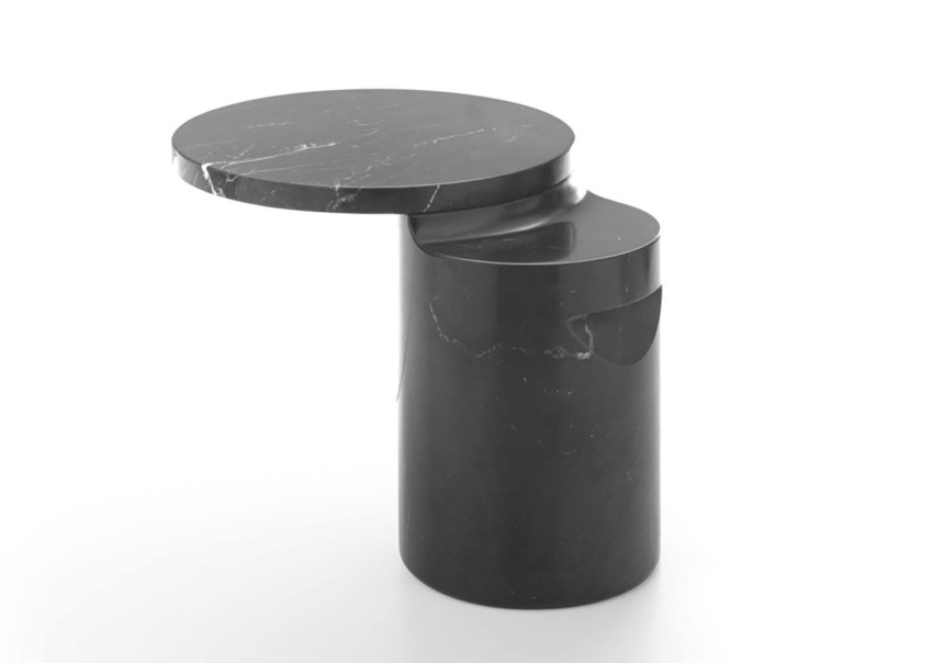 Modern black marble side table with one round and one oval surface against a white background.