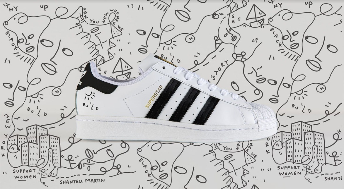 Adidas Superstar sneakers with black stripes on artistic background featuring abstract designs and supportive women messages.