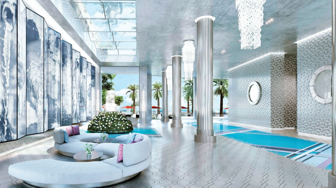 Luxury indoor pool area with modern decor, column pillars, and large windows showcasing palm trees and a sunlit exterior.