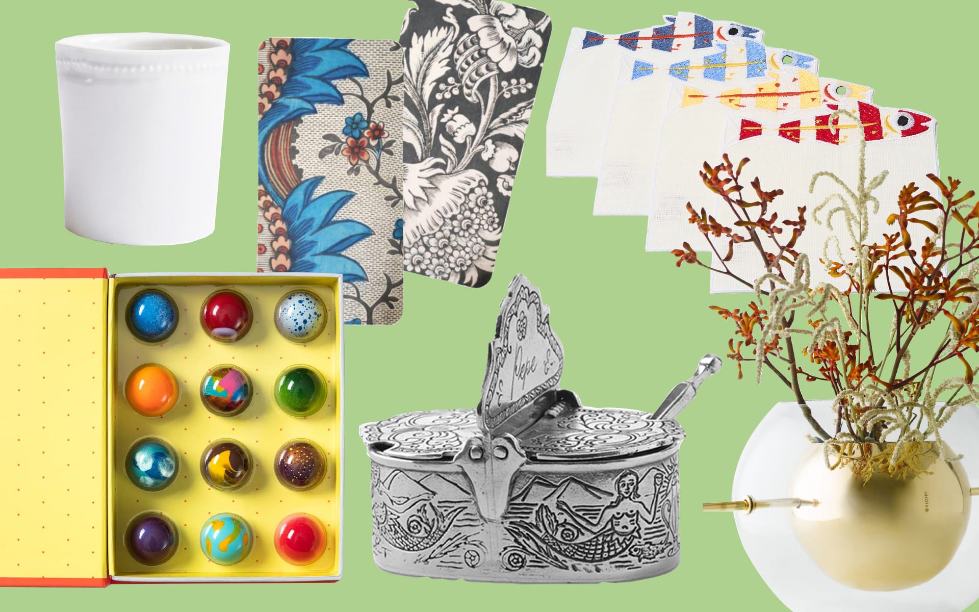 Decorative items including pottery, floral cards, colorful chocolates, ornate box, fish-shaped tape, and dried floral arrangement.