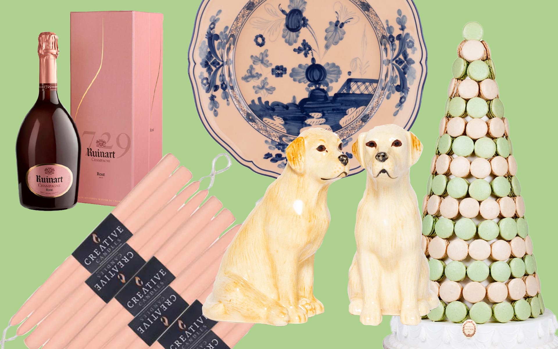 Gift items including champagne, decorative plates, candles, dog figurines, and a macaron tower arranged on a green background.