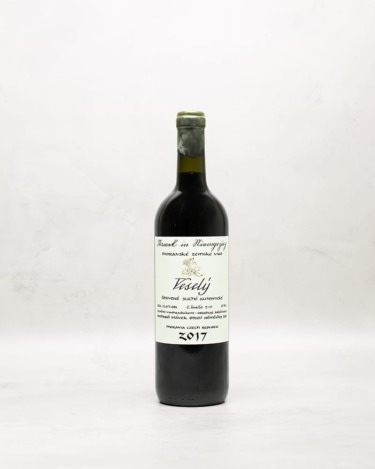 Bottle of red wine with a label, set against a light background.
