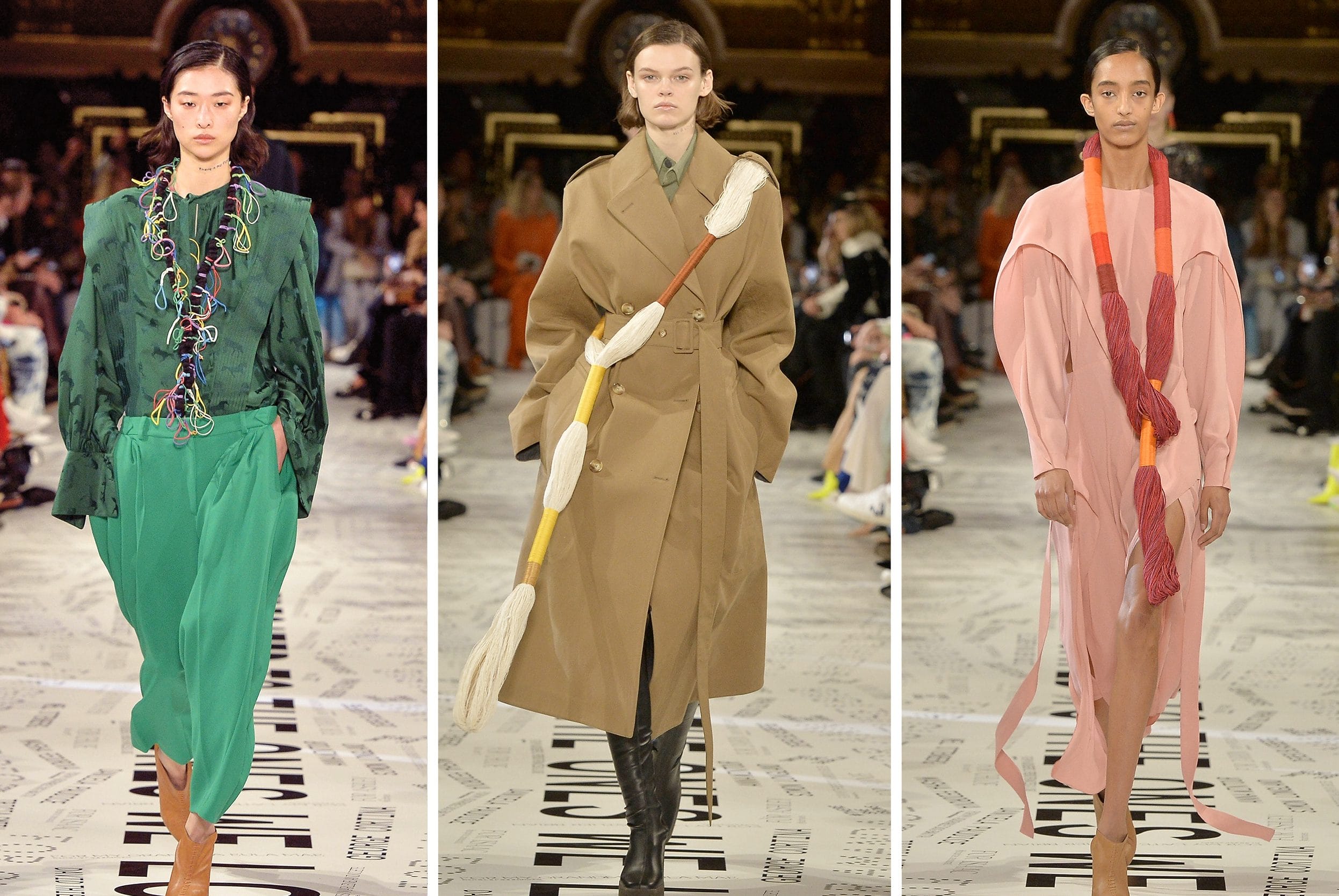 Three models showcase modern fashion outfits on a runway, each wearing colorful and uniquely designed ensembles.