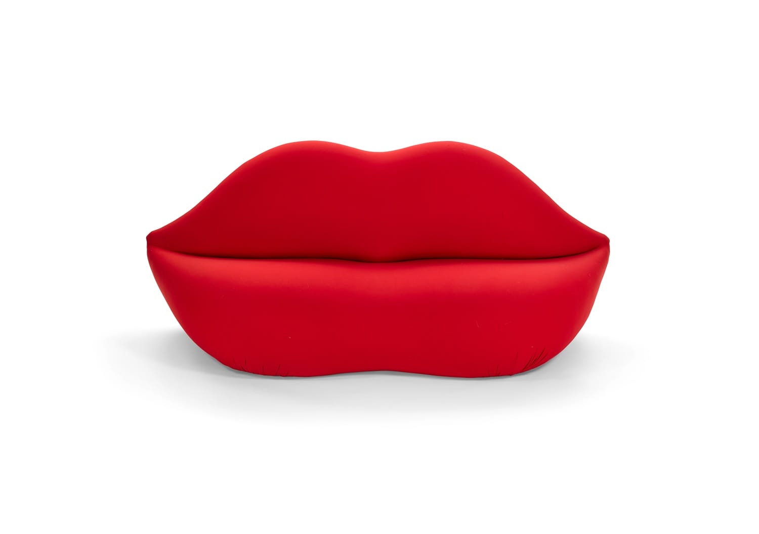 Red lip-shaped sofa with a smooth, modern design on a white background.