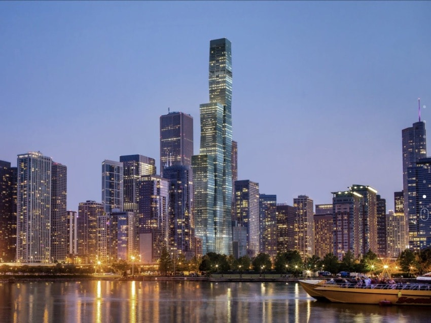 Chicago skyline at dusk with illuminated skyscrapers and reflections on the water.
