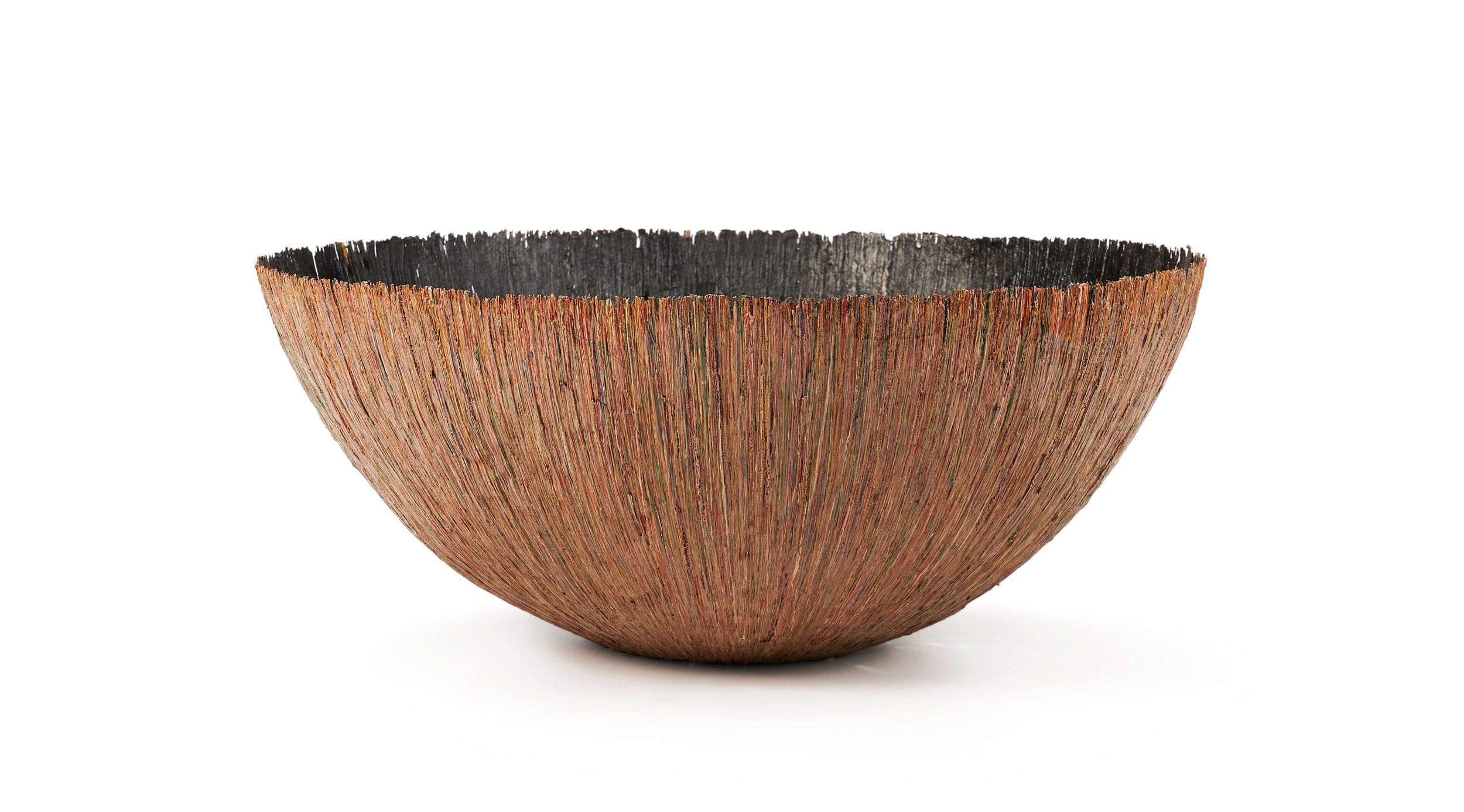 Handcrafted bowl with textured, multicolored fringe design, featuring a wide, shallow shape on a plain white background.