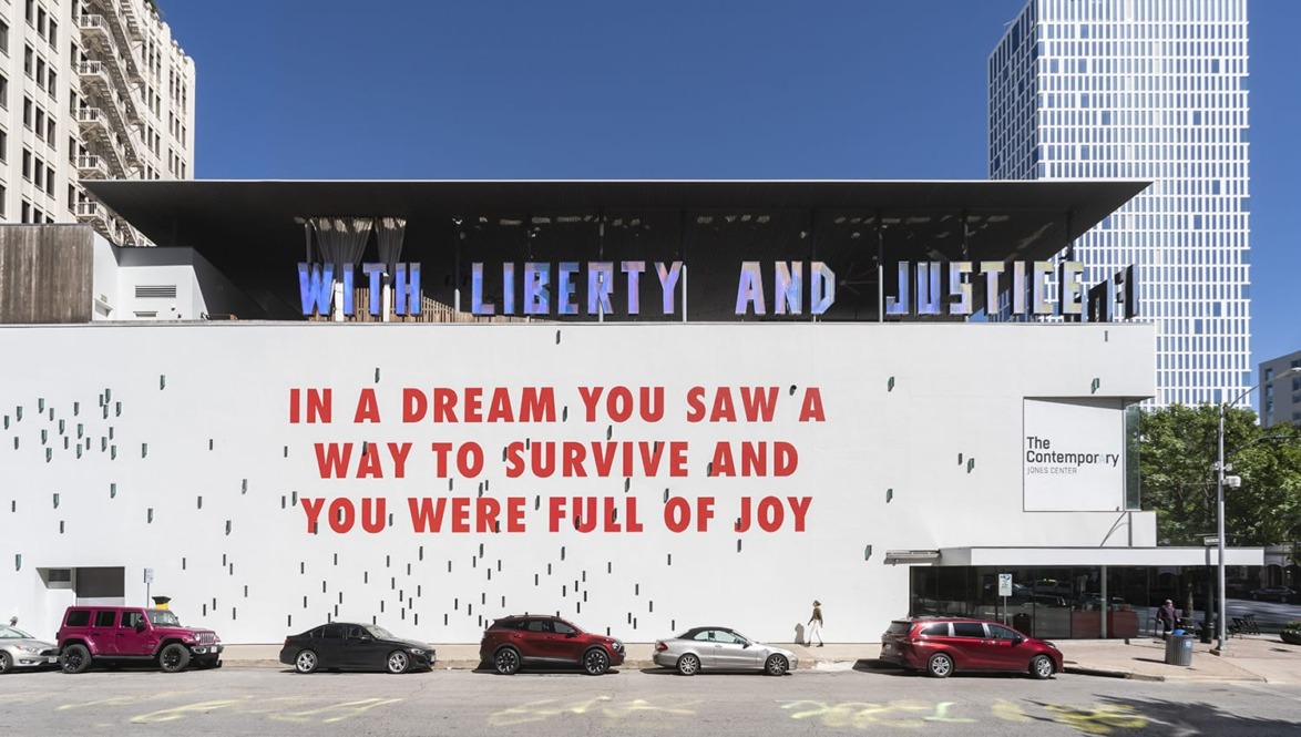 Public art mural with text: "With liberty and justice... In a dream, you saw a way to survive and you were full of joy."