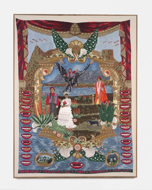 Colorful embroidered tapestry featuring people, animals, and scenic landscapes with intricate patterns and decorative elements.