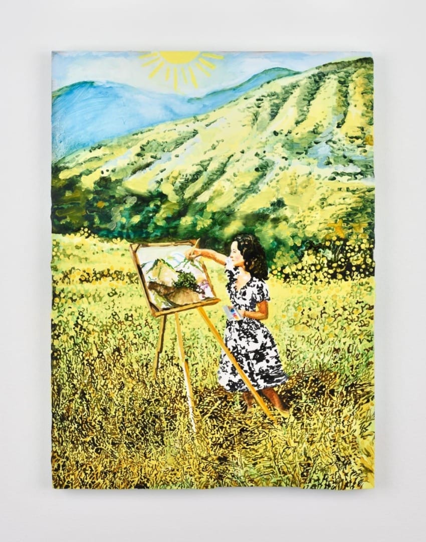 A woman painting on an easel in a sunny, yellow flower field with mountains in the background.