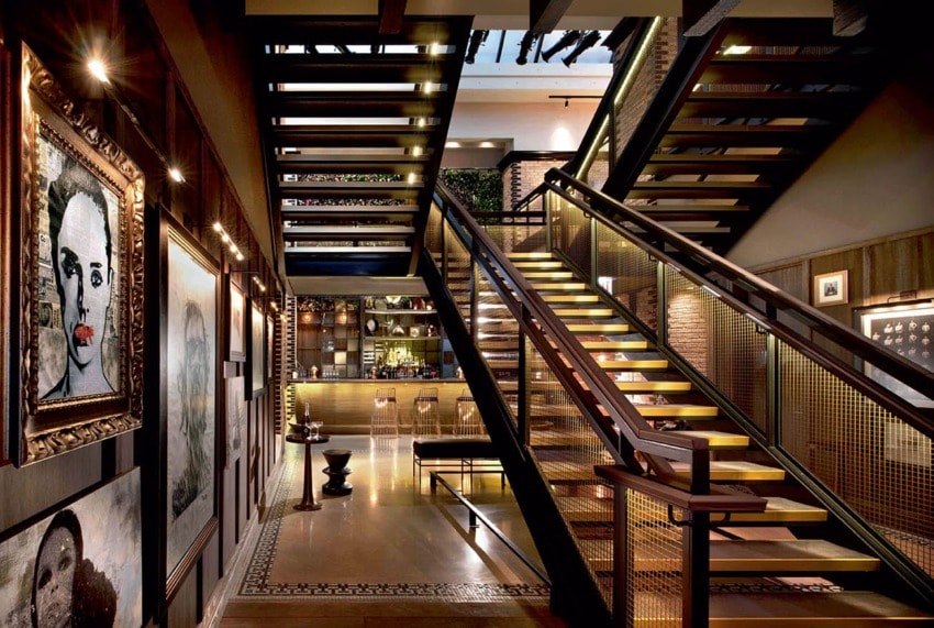 Modern staircase with artistic decor and warm lighting in a stylish interior space.