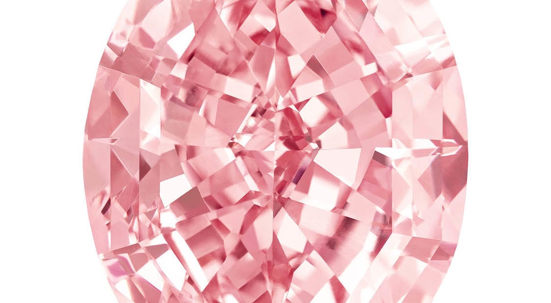 Sparkling pink diamond with intricate faceting, showcasing its brilliant cut and vibrant color against a white background.