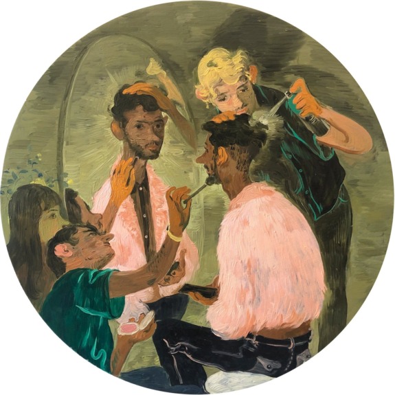 A group of people grooming and styling a man, with a mirror reflecting the scene.