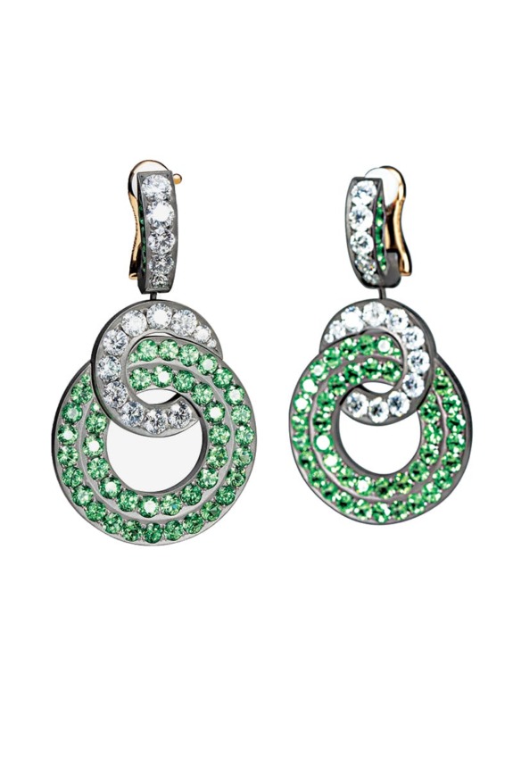 Green and white gemstone earrings with circular intertwined design on a white background.