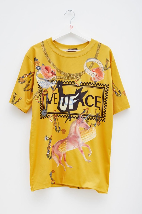 Yellow graphic t-shirt featuring unicorns and floral designs with the phrase "Live Peace" across the front.