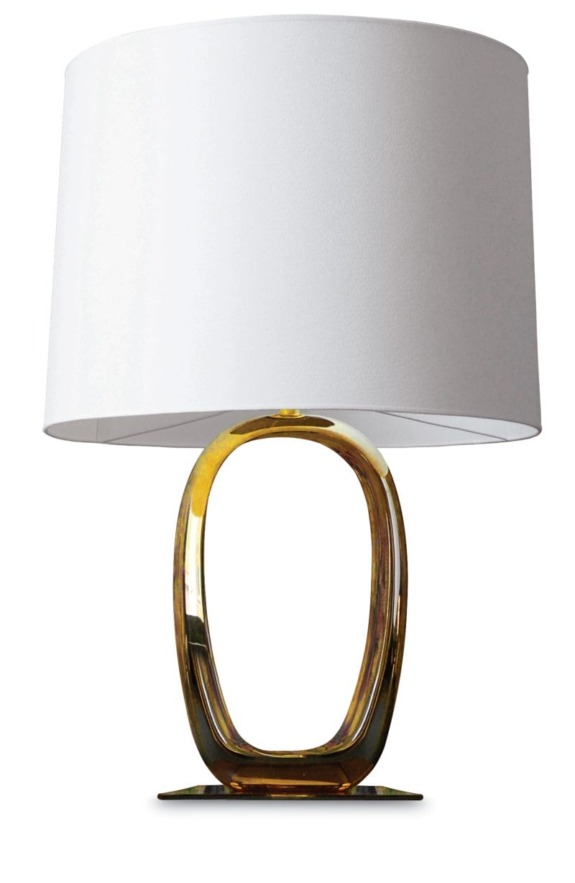 Modern table lamp with a large white shade and an oval amber glass base.