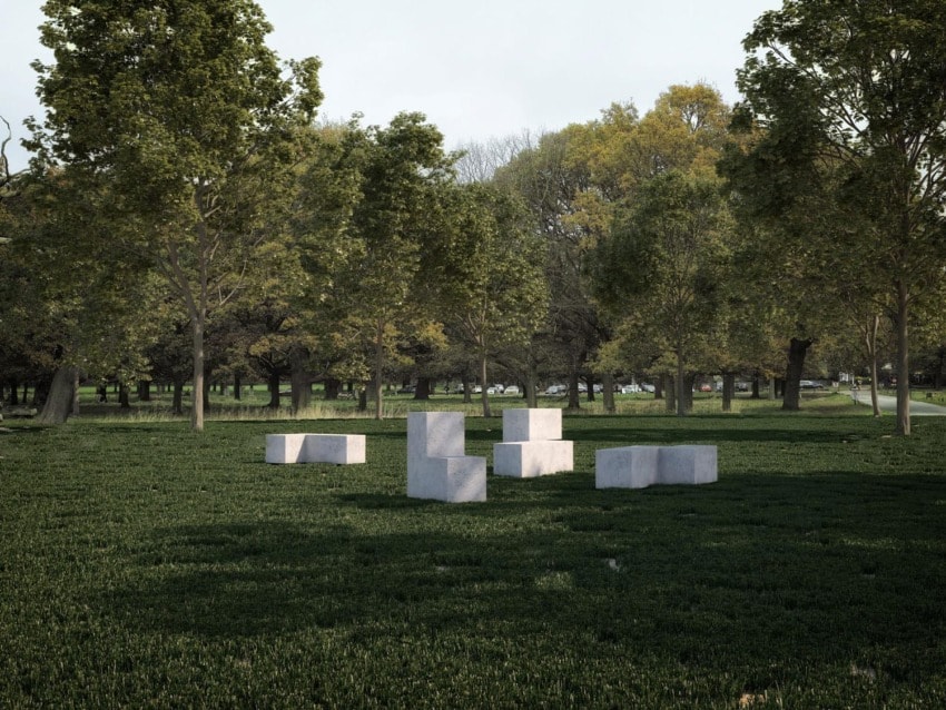 Concrete sculptures arranged in a grassy park surrounded by trees and a few distant people walking along a path.