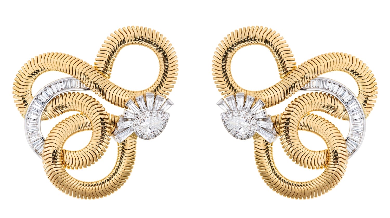 Vintage gold and diamond earrings with intricate spiral design and baguette cut stones on a white background.