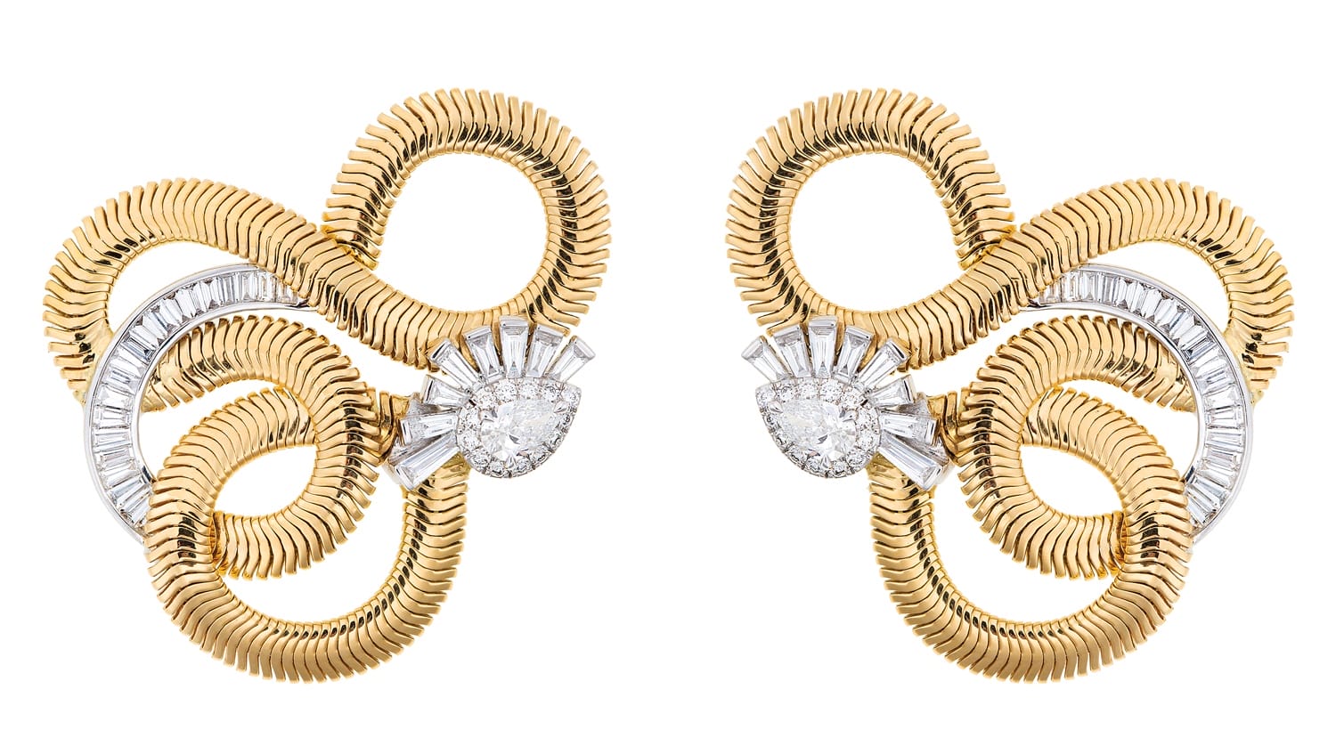 Vintage gold and diamond earrings with intricate spiral design and baguette cut stones on a white background.