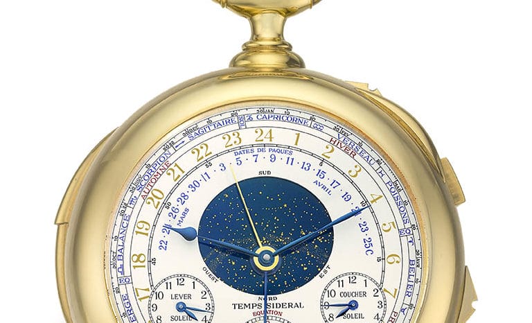 Gold vintage pocket watch with intricate dials showing time, date, and zodiac symbols against a white background.