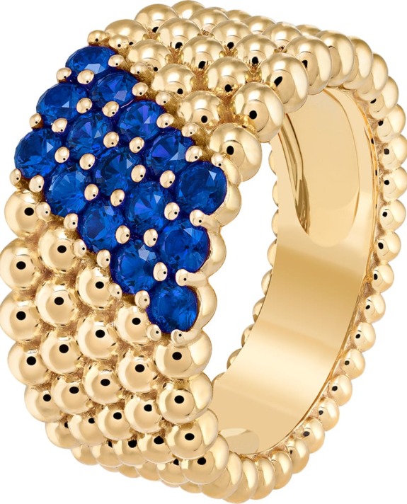 Gold ring with cluster of blue gemstones on the top, featuring a textured, beaded design around the band.