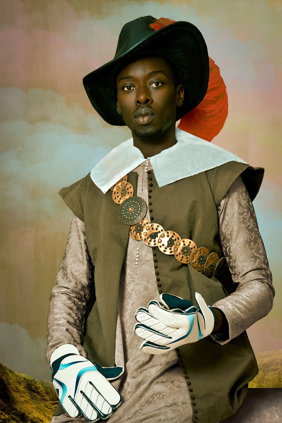 Person in brown historical attire, wearing a large black hat with feather, holding baseball gloves, against a painted backdrop.