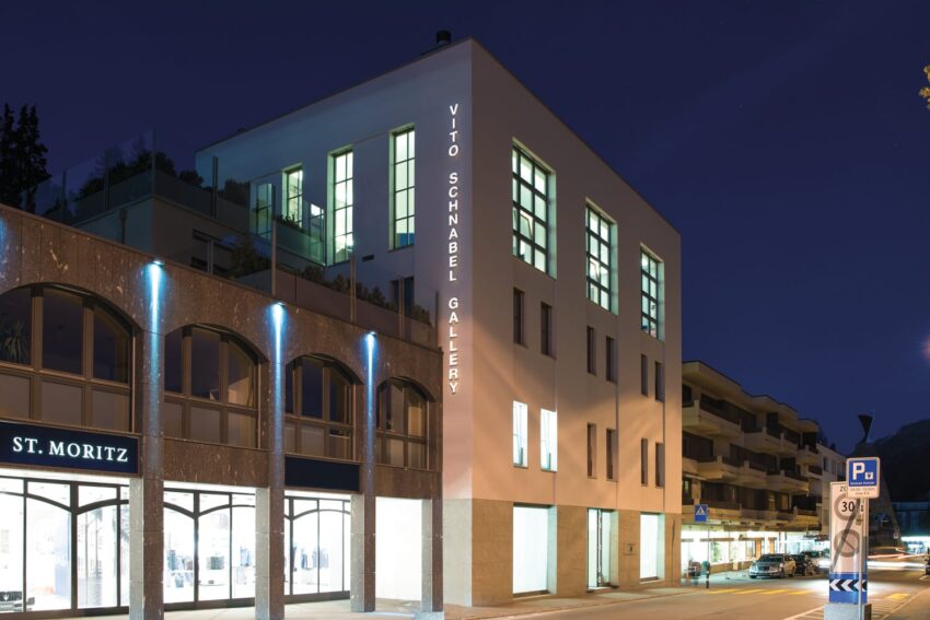 night view of a modern gallery building with illuminated windows and Vito Schnabel Gallery signage in an urban setting