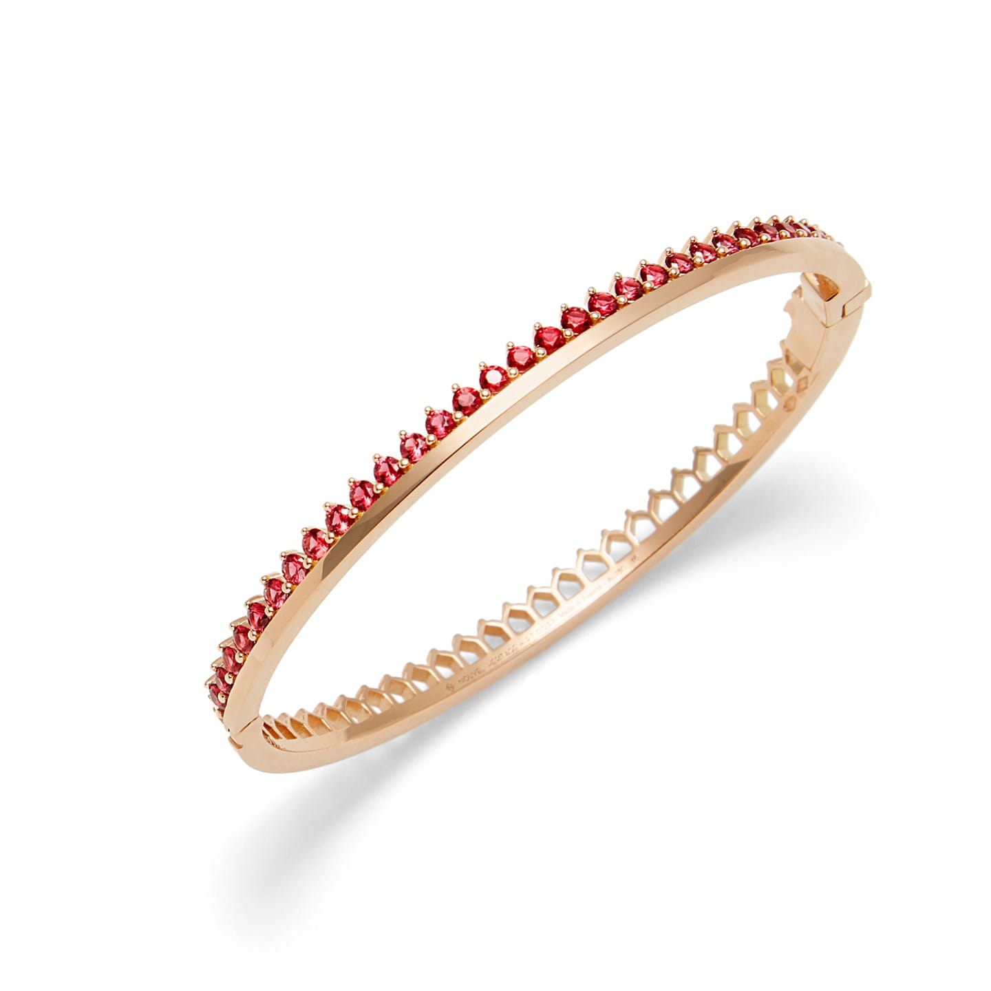 Gold bracelet adorned with red gemstones, featuring a delicate and elegant design.