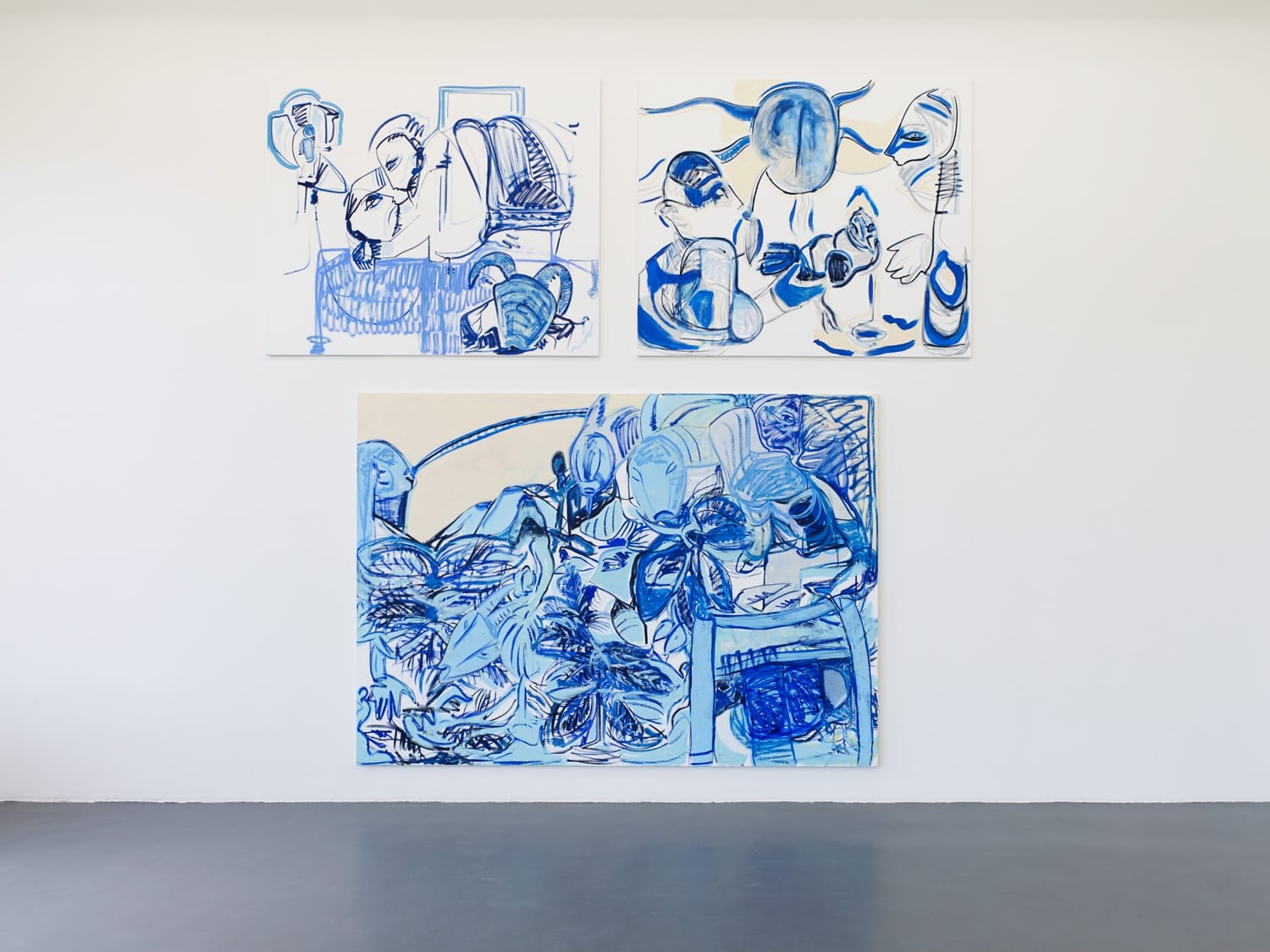 Three abstract blue and white paintings displayed on a white wall in an art gallery setting.