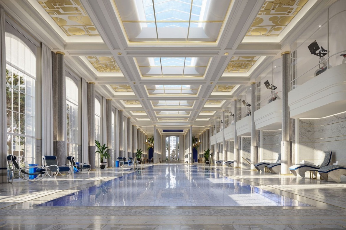 Luxurious indoor pool with elegant columns, sunlit skylights, marble floors, and blue lounge chairs in a grand hall.