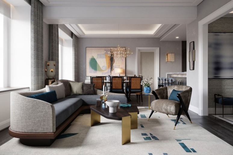 Modern living room with gray sofa, unique armchair, abstract art, and large windows allowing natural light.