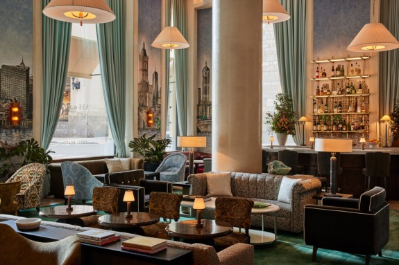 Cozy hotel bar lounge with elegant seating, ambient lighting, and a well-stocked bar in the background.