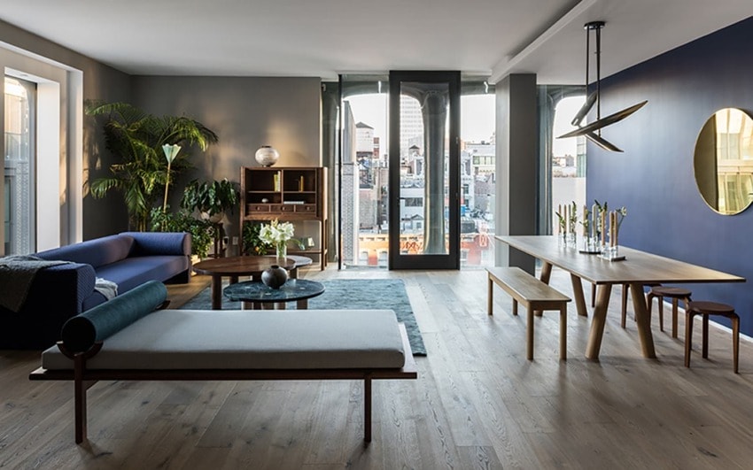 Modern living room and dining area with wooden furniture, large windows, and city view.