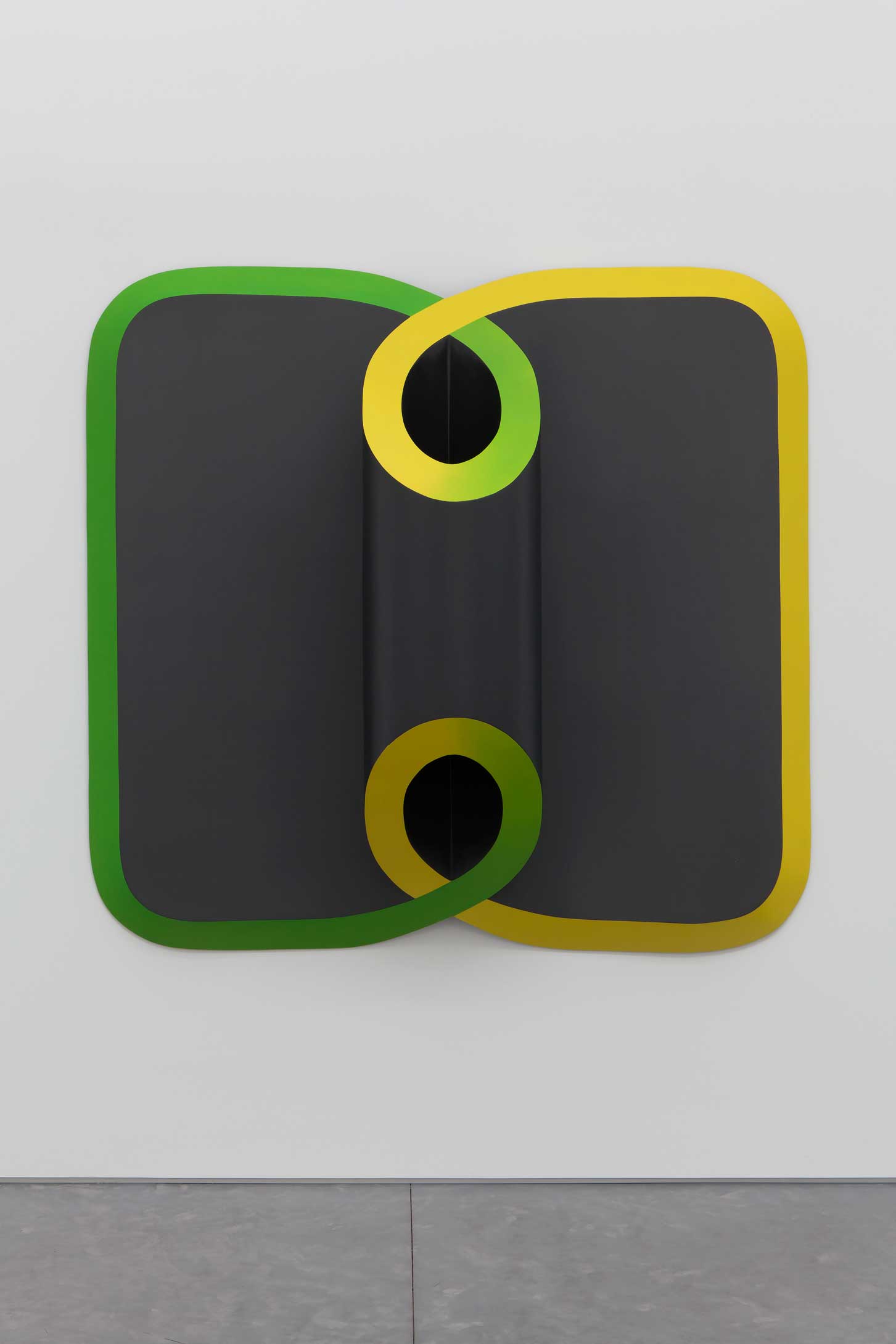 Abstract wall art with intersecting black, green, and yellow shapes creating a symmetrical and geometric design.