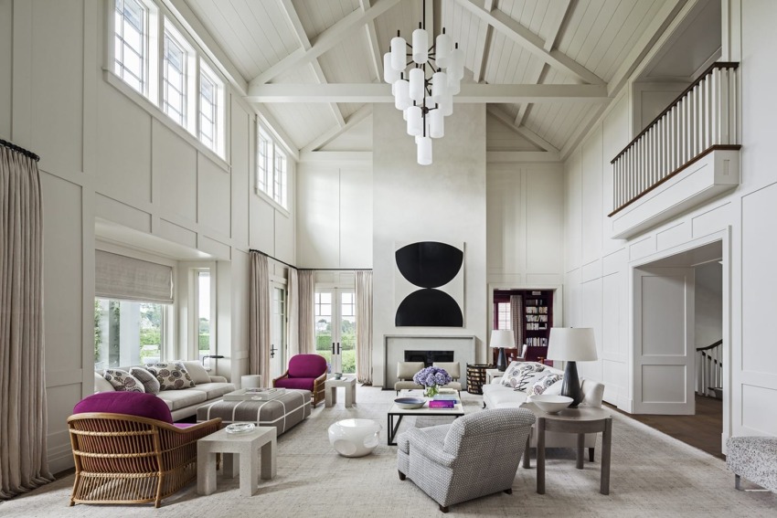 Spacious living room with high ceilings, modern chandelier, large windows, and a mix of contemporary and classic furniture.