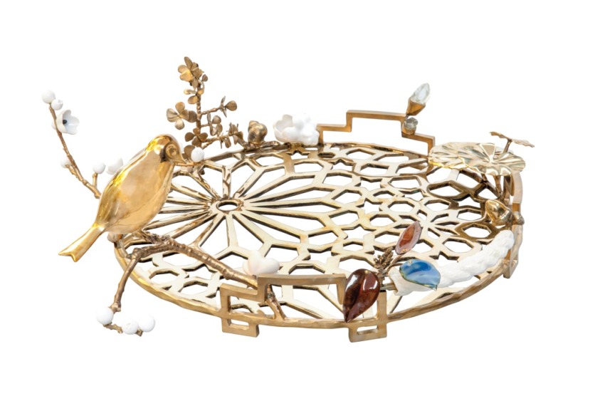 Decorative gold tray with intricate cut-out design, featuring a bird and floral embellishments, including colorful accents.