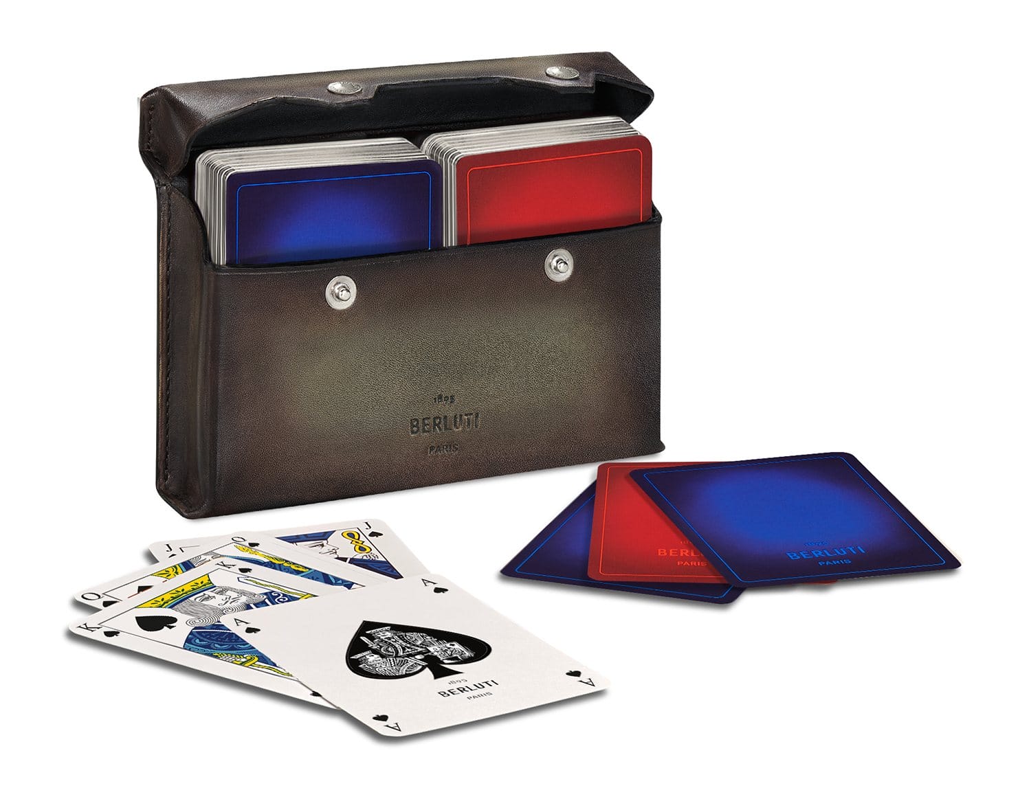 Leather case with two decks of stylish playing cards, one red, one blue, scattered and stacked on white surface.