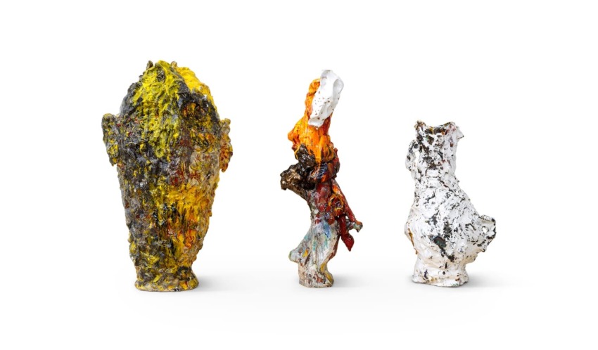 Three abstract, colorful sculptures on a white background, each uniquely textured and shaped.