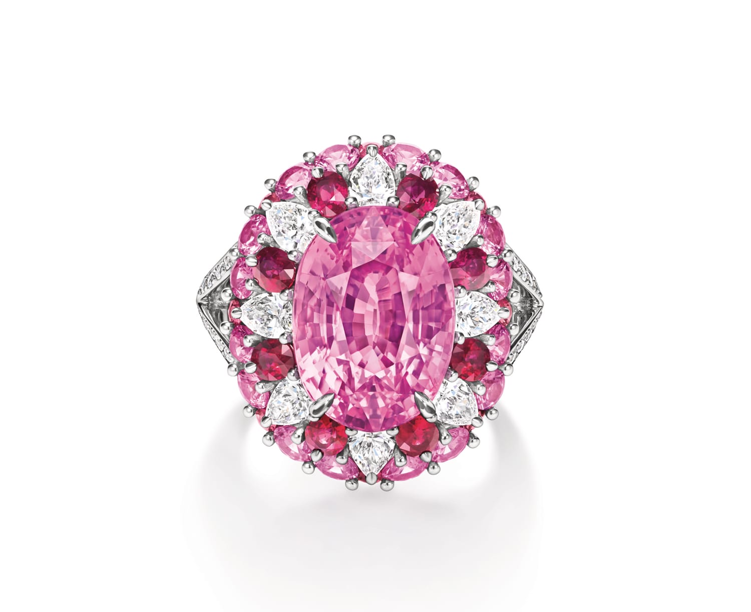 Oval pink gemstone ring with a diamond and pink stone halo, set in a detailed silver band shown on a white background.