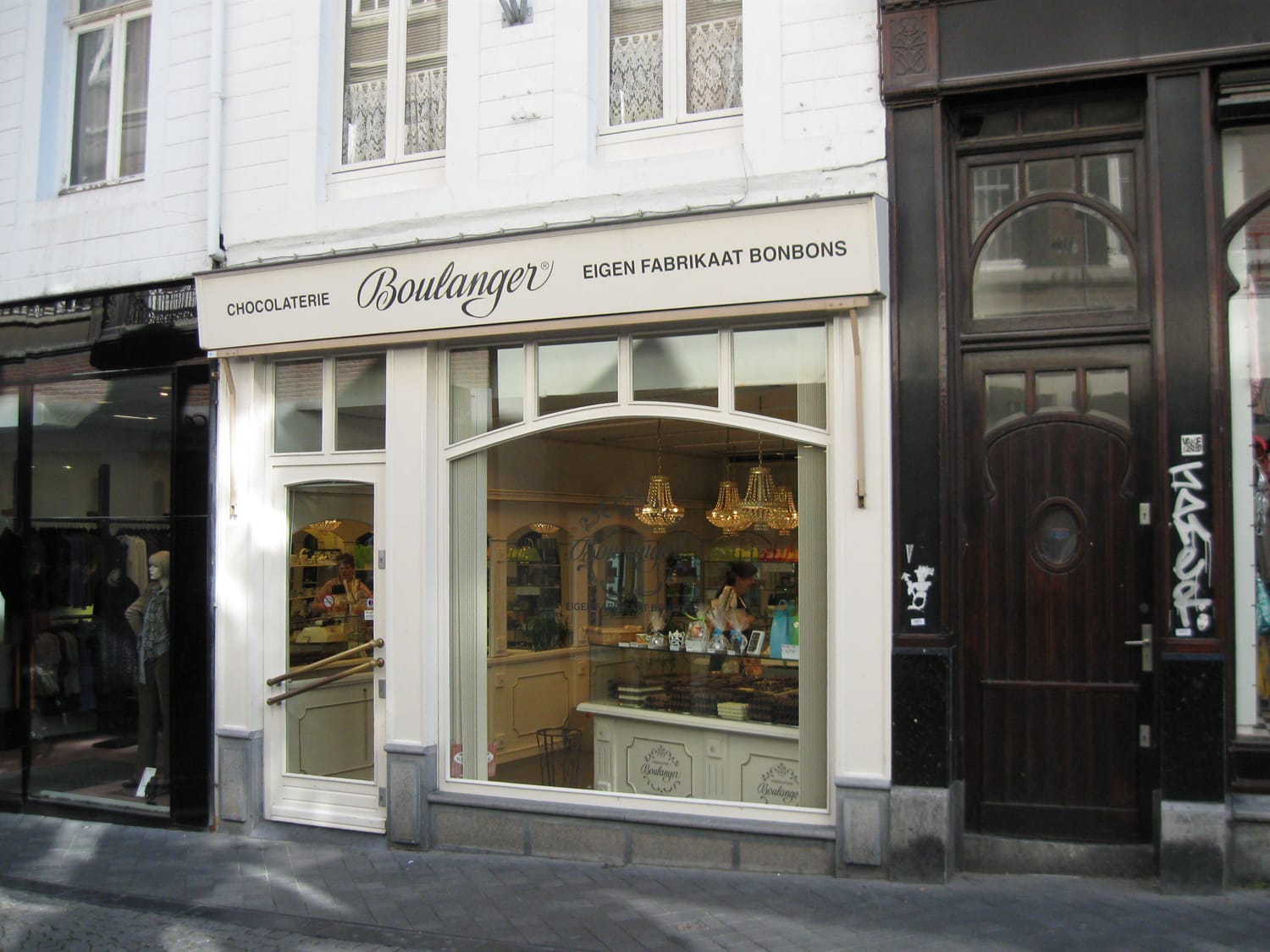 Chocolaterie shopfront with large display windows, labeled "Boulanger," located on a city street.