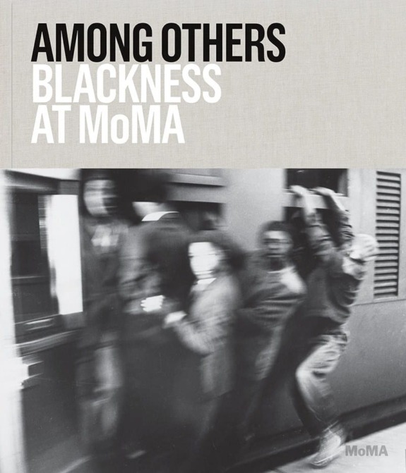Cover of "Among Others: Blackness at MoMA" showing a blurred black and white image of people moving by a train.